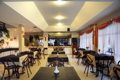 a restaurant with tables and chairs in a room at Hotel Salerno in Villa Carlos Paz