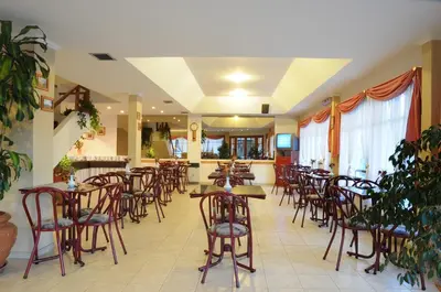 a restaurant with tables and chairs in a room at Hotel Salerno in Villa Carlos Paz