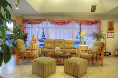 a living room with a couch and chairs and a table at Hotel Salerno in Villa Carlos Paz