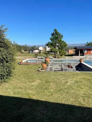 a backyard with a swimming pool and a grass yard at Rancho la alborada in Los Reartes
