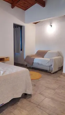 a bedroom with two beds and a rug at Rancho la alborada in Los Reartes