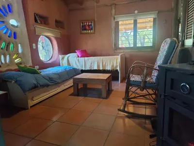 a living room with a couch and a table at Alma de Adobe in Merlo
