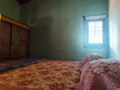 a bedroom with a bed and a window at Alma de Adobe in Merlo