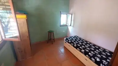 a small room with a bed and a window at Alma de Adobe in Merlo