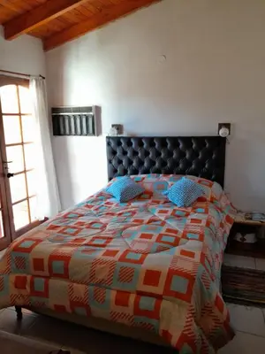 a bedroom with a bed with a colorful quilt at Alquiler Temporario Zona Céntrica En Córdoba in Cordoba