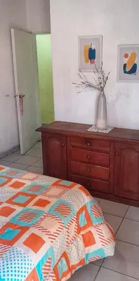 a bedroom with a bed and a vase on a dresser at Alquiler Temporario Zona Céntrica En Córdoba in Cordoba