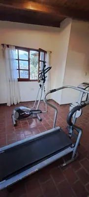 a room with a gym with a treadmill and a window at Alquiler Temporario Zona Céntrica En Córdoba in Cordoba