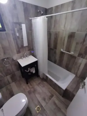 a bathroom with a toilet and a shower and a sink at FlussHaus VGB in Villa General Belgrano