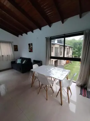 a living room with a white table and chairs at FlussHaus VGB in Villa General Belgrano