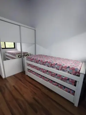 a bedroom with a bed and a mirror at FlussHaus VGB in Villa General Belgrano