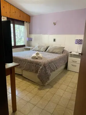 a bedroom with a bed with two towels on it at POSADA DEL CENTRO in Villa General Belgrano
