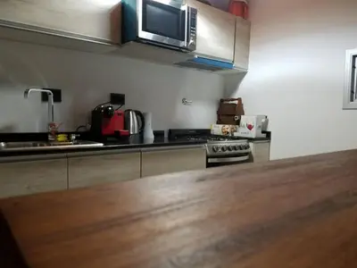 a kitchen with a counter top and a microwave at Cabaña La Ilusión in Villa Ciudad Parque