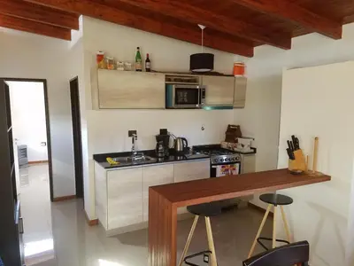 a kitchen with a counter and a counter top at Cabaña La Ilusión in Villa Ciudad Parque