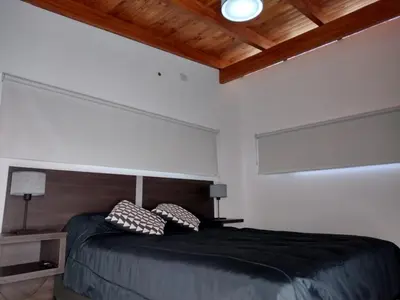 a bedroom with a bed with two pillows on it at Cabaña La Ilusión in Villa Ciudad Parque