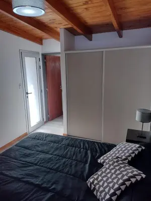a bedroom with a large bed and a wooden ceiling at Cabaña La Ilusión in Villa Ciudad Parque
