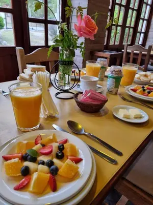 a table with a plate of fruit and juice at Cabanias El Aguaribay in San Javier