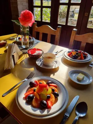 a table with plates of food on a table at Cabanias El Aguaribay in San Javier