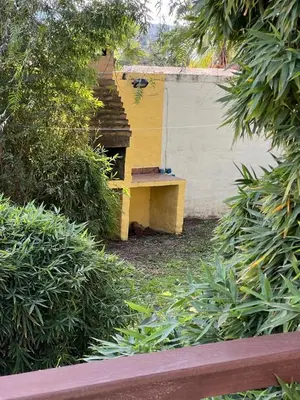 a yellow bench sitting next to a building at Cabañas Los Cedros in Tanti