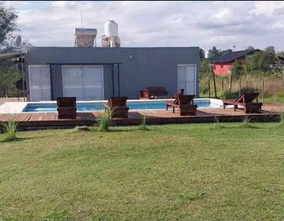 a house with a swimming pool and some chairs at Casa de Valentino in Potrero de Garay