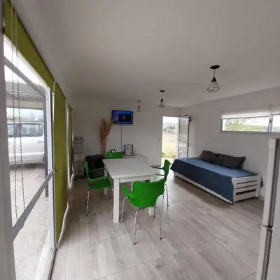 a room with a bed and a table and chairs at Casa de Valentino in Potrero de Garay