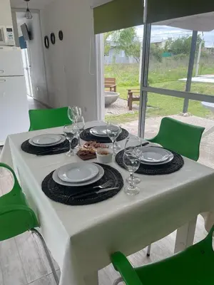 a white table with plates and wine glasses on it at Casa de Valentino in Potrero de Garay