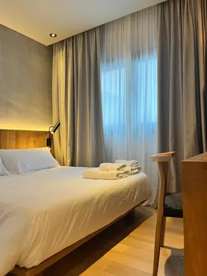 a hotel room with a bed and a window at Casa Papagayo in Cordoba