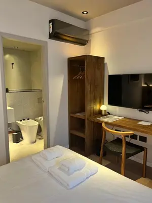 a bedroom with a bed and a desk with a computer at Casa Papagayo in Cordoba