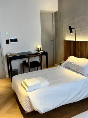 a bedroom with a white bed and a desk at Casa Papagayo in Cordoba