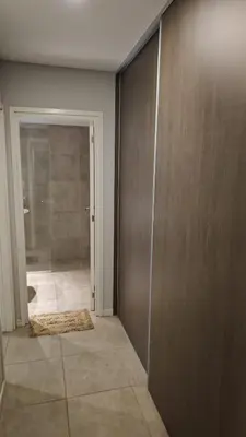 a bathroom with a shower and a sliding door at Departamento con seguridad 24hs, gym y pileta! in Cordoba