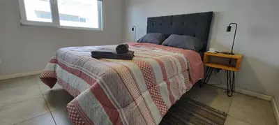 a bedroom with a bed with a hat on it at Departamento con seguridad 24hs, gym y pileta! in Cordoba