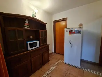 a kitchen with a refrigerator and a microwave at Cabanas Las Pencas, HOSTERIA in Mina Clavero