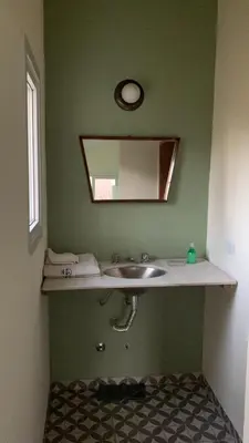 a bathroom with a sink and a mirror at La Casita in Los Reartes