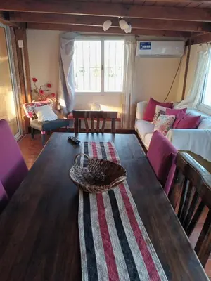 a living room with a table and a couch at Departamento próximo terminal y hospitales in Cordoba