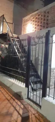 a metal fence with a staircase in a building at Departamento próximo terminal y hospitales in Cordoba