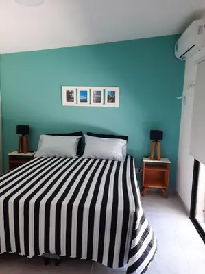a bedroom with a bed with a blue wall at Lacus. Casas de lago. in Almafuerte