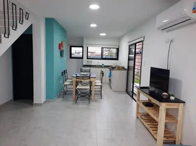 a kitchen and dining room with a table and chairs at Lacus. Casas de lago. in Almafuerte
