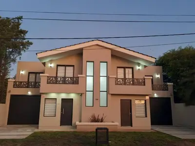 a large house with a balcony on top of it at Lacus. Casas de lago. in Almafuerte