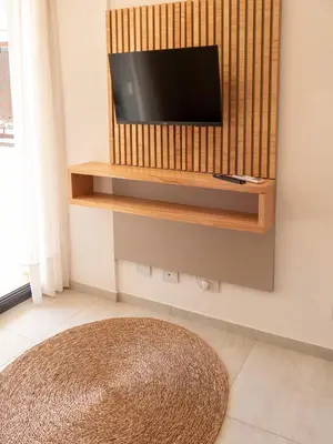a living room with a television on a wall at Departamentos General Paz by Lugar in Cordoba