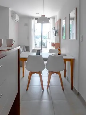 a kitchen and dining room with a table and chairs at Departamentos General Paz by Lugar in Cordoba