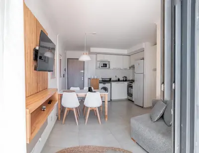 a kitchen and living room with a table and chairs at Departamentos General Paz by Lugar in Cordoba