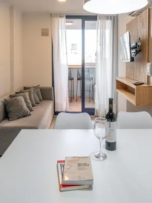 a living room with a table with a wine glass at Departamentos General Paz by Lugar in Cordoba