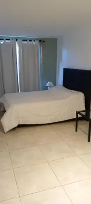 a bed sitting in a room with a tiled floor at Das thomy in Cordoba