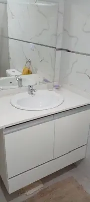 a white bathroom with a sink and a mirror at Das thomy in Cordoba