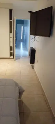 a room with a bed and a flat screen tv on the wall at Das thomy in Cordoba