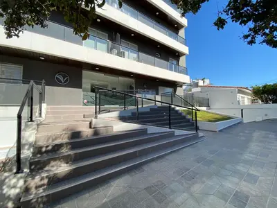 a building with stairs in front of it at Edificio Veneto III - Departamento de un dormitorio a pocas cuadras del centro in Villa Carlos Paz