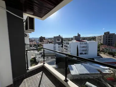 a balcony with a view of a city at Edificio Veneto III - Departamento de un dormitorio a pocas cuadras del centro in Villa Carlos Paz