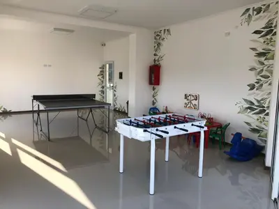 a room with a table with a bunch of wine bottles at Edificio Veneto IV - Departamento de un dormitorio a una cuadra de la peatonal in Villa Carlos Paz