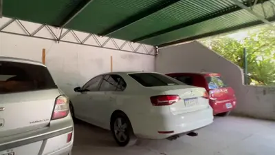 two cars are parked in a garage at La Casa de Pipa in Mina Clavero