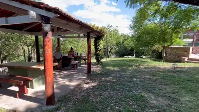 a picnic table under a pavilion in a park at La Casa de Pipa in Mina Clavero