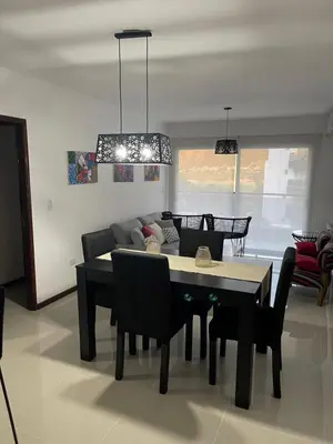 a living room with a table and a couch at Veneto Village in Villa Parque Siquiman